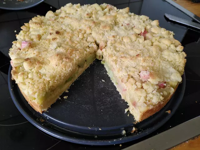 Ein angeschnittener Rhabarberstreuselkuchen